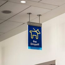 pet drop off sign hanging from a ceiling